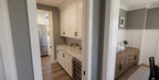 Wexford prep kitchen beverage center with white cabinetry, stone countertops, and a beverage refrigerator.