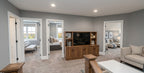Wexford upper-level loft with a TV cabinet and entrances to adjacent bedrooms.