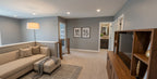 Wexford upper-level loft with a sofa and TV overlooking the staircase.