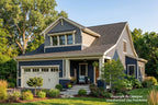 A two-story suburban house with dark blue-gray siding, white trim, a white garage door, and a front porch, surrounded by a green lawn and trees under a blue sky.