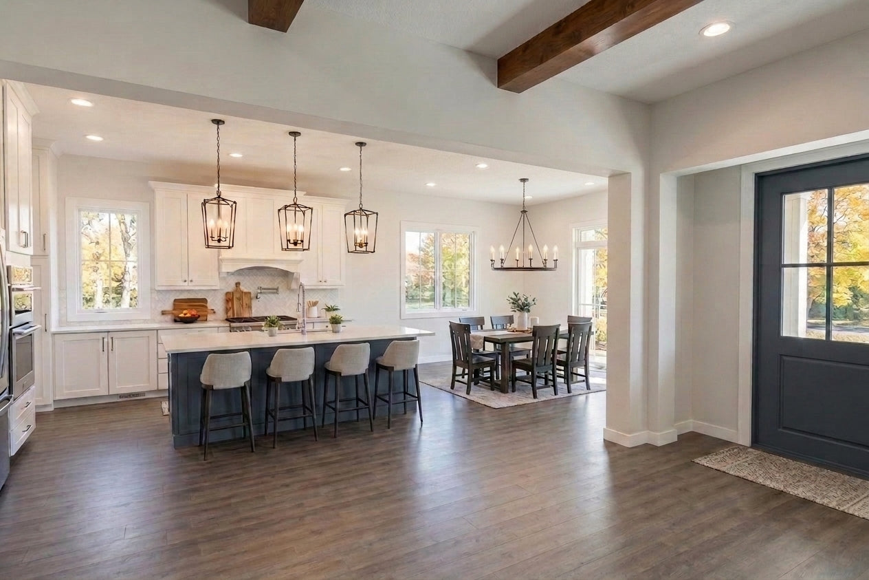 Modern kitchen and dining area with wooden floors and white walls.