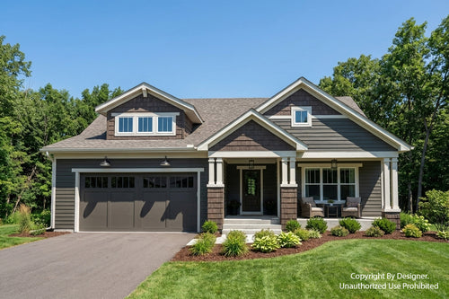 Two-story house with gray siding and white trim, surrounded by greenery.