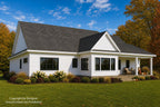 Angled rear view of Alder Glen with white siding, black-framed windows, a covered porch and autumn landscaping.