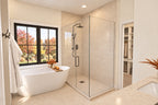 Primary bathroom with an oval freestanding tub beneath a window and a glass shower with a vertical door handle.