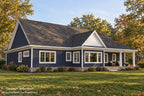 Angled rear exterior of Willow Cove with navy siding, a white dining-room gable and a covered rear porch in autumn.