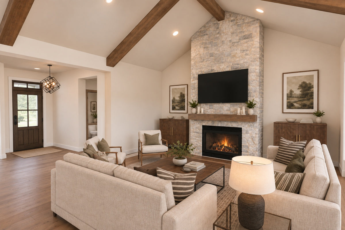 Willow Cove great room facing the stone fireplace and foyer, with cream seating arranged around a wood coffee table.