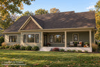 Rear exterior of Oak Haven showing black-framed windows, a covered porch with seating and steps leading to the autumn lawn.