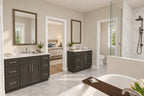 Primary bathroom with two dark vanities, a freestanding tub and a glass-enclosed shower.