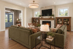 Great-room rendering with a stone fireplace, built-in cabinets and a view toward the foyer.
