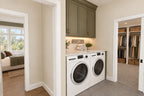 Laundry rendering with a washer and dryer between the primary bedroom and walk-in closet.
