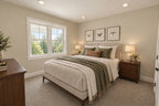 Upstairs-bedroom rendering with a large window, bedside tables and framed artwork.