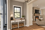 Foyer rendering with a console table beneath a window and a view of the great-room fireplace.