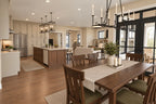 Dining-area rendering with a wood table beside the open kitchen and rear windows.