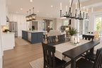 View from the dining table across the kitchen island to the great room and front entry.
