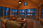 Screened porch rendering with a vaulted wood ceiling, sofa, leather chair and wide lake views at dusk.