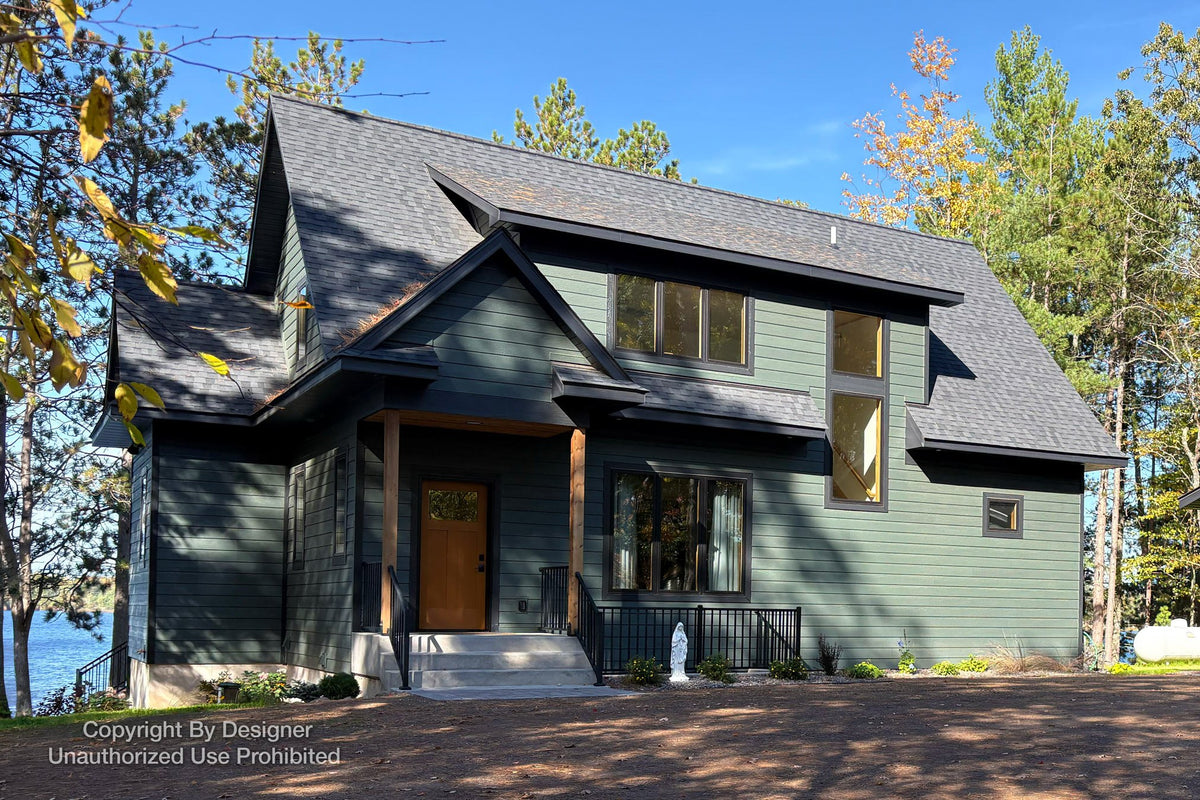 Angled front cottage rendering with green siding, a covered entry and an upper dormer.
