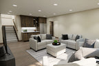 Lower-level family room rendering with seating, a wet bar and stairs to the main level.