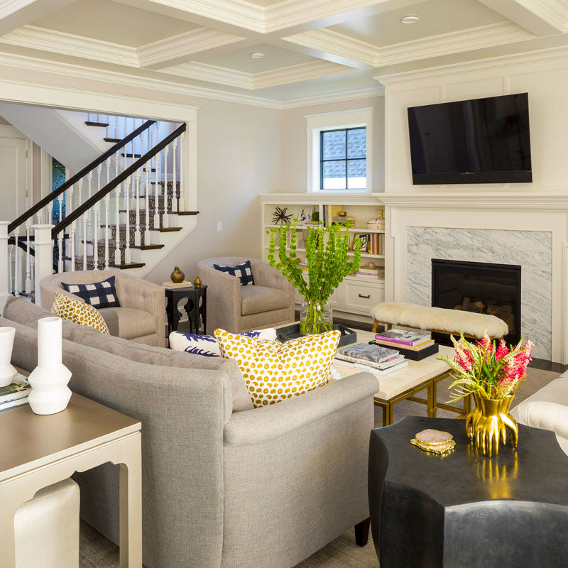 Custom home great room by Royal Oaks Design Inc with coffered ceiling, marble fireplace, open staircase, and transitional furnishings